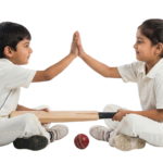 Boy and Girl Cricket Players Sitting and Giving High Five