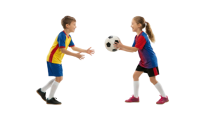 Boy and Girl Playing Soccer Passing Football Ball