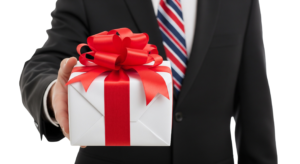 Businessman Hand Holding Out Red Ribbon Gift Box Present