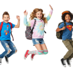 Cheerful Kids Jumping for Joy Carrying School Backpacks