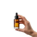 Hand Holding Essential Oil Dropper Bottle Isolated