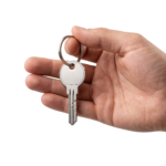 Hand Holding Metal House Key Ring Isolated