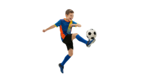 Young Soccer Player Kicking Football Ball Mid Air Jump